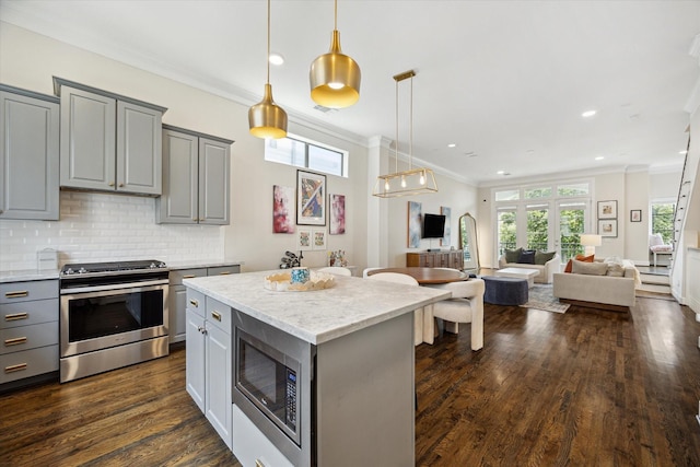 1207 W 24th St Unit A, Houston, TX 77008 - kitchen with gray cabinetry, stainless steel appliances, open floor plan, tasteful backsplash, and crown molding