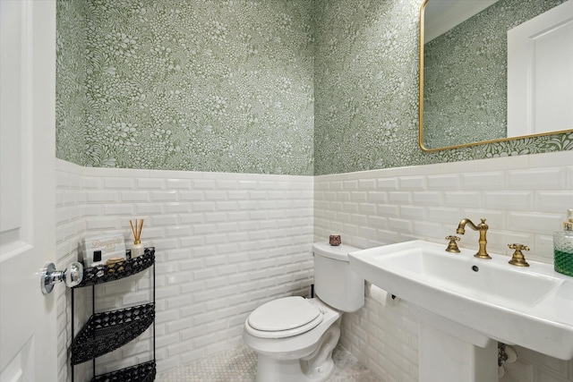 1207 W 24th St Unit A, Houston, TX 77008 - half bath with a wainscoted wall, tile walls, wallpapered walls, and tile patterned flooring