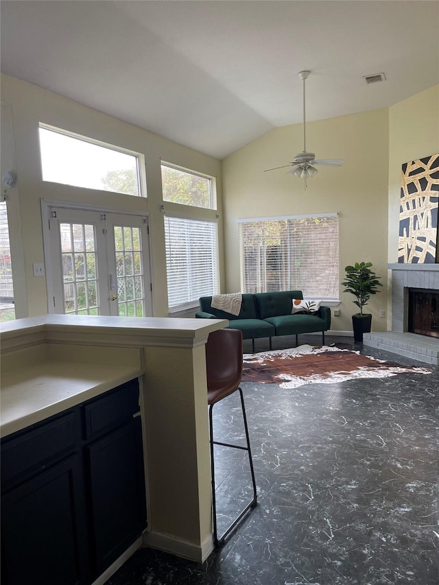 18534 Trail Bend Ln, Houston, TX 77084 - living area with a brick fireplace, vaulted ceiling, a ceiling fan, and french doors