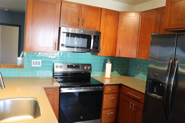 16542 John Silver Rd, Jamaica Beach, TX 77554 - kitchen featuring refrigerator with ice dispenser, stainless steel microwave, electric stove, light countertops, and backsplash