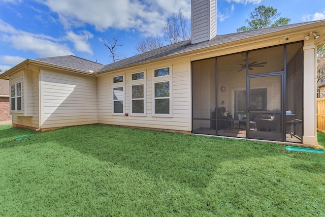 3816 Mystic Cir, Montgomery, TX 77356 - rear view of house with a sunroom, a chimney, a lawn, and ceiling fan