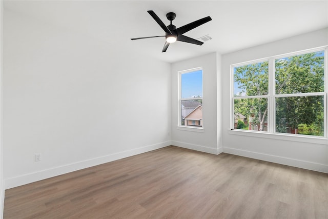 412 E 34th St, Houston, TX 77018 - empty room with light wood-style flooring, healthy amount of natural light, and a ceiling fan