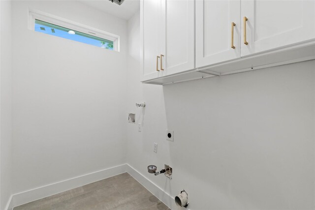 412 E 34th St, Houston, TX 77018 - washroom with gas dryer hookup, cabinet space, hookup for a washing machine, and hookup for an electric dryer