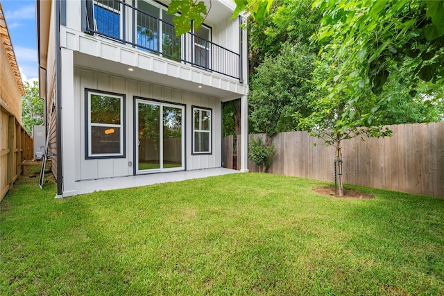412 E 34th St, Houston, TX 77018 - rear view of house featuring a balcony, board and batten siding, and a fenced backyard