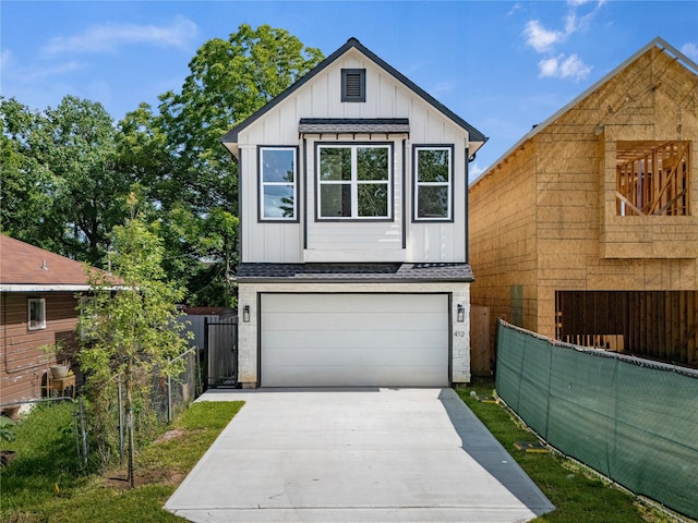 412 E 34th St, Houston, TX 77018 - view of front of home with board and batten siding, roof with shingles, driveway, and brick siding