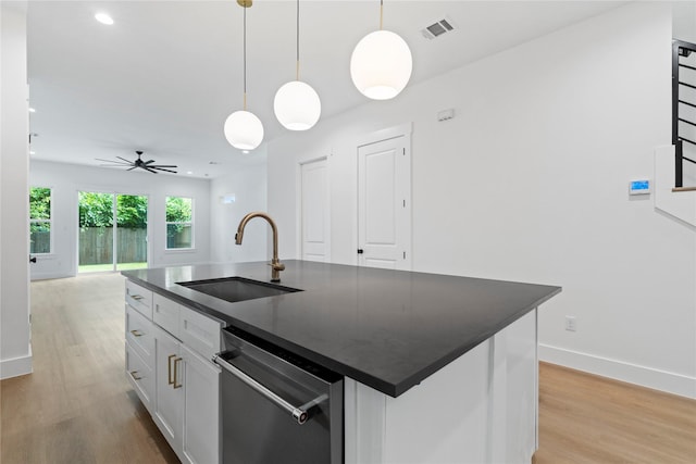 412 E 34th St, Houston, TX 77018 - kitchen with dishwasher, dark countertops, light wood-style floors, and recessed lighting