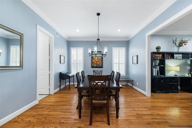 983 W 42nd St, Houston, TX 77018 - dining room with a chandelier, healthy amount of natural light, light wood-type flooring, recessed lighting, and crown molding