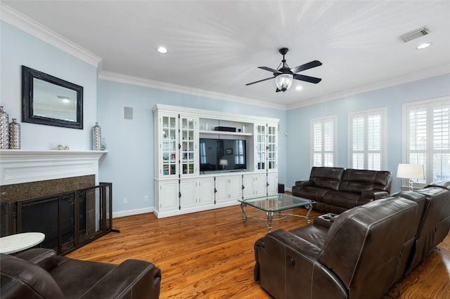 983 W 42nd St, Houston, TX 77018 - living room with ceiling fan, wood finished floors, ornamental molding, a fireplace, and recessed lighting