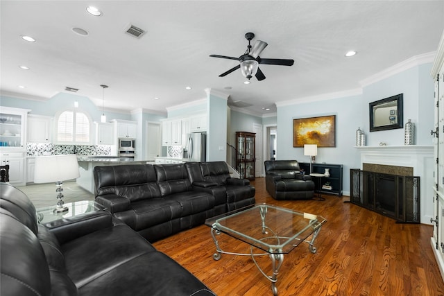 983 W 42nd St, Houston, TX 77018 - living room featuring a ceiling fan, a fireplace, recessed lighting, wood finished floors, and ornamental molding