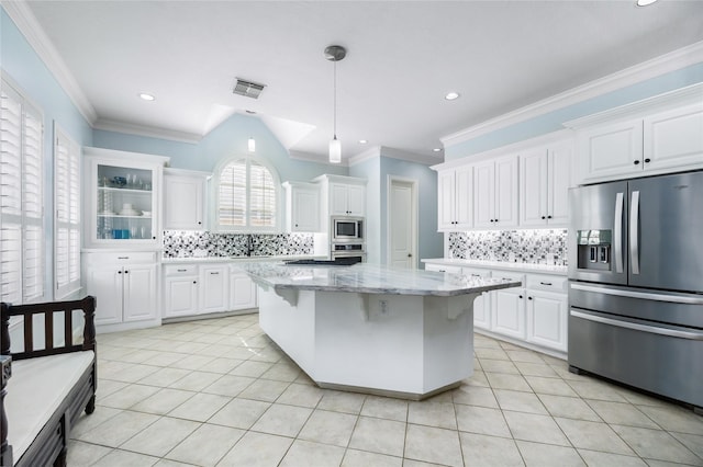 983 W 42nd St, Houston, TX 77018 - kitchen featuring stainless steel appliances, decorative backsplash, light tile patterned floors, ornamental molding, and recessed lighting