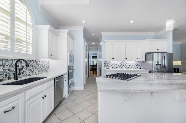 983 W 42nd St, Houston, TX 77018 - kitchen featuring stainless steel appliances, crown molding, decorative backsplash, white cabinets, and a warming drawer