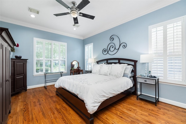 983 W 42nd St, Houston, TX 77018 - bedroom with wood finished floors, ornamental molding, a ceiling fan, and recessed lighting