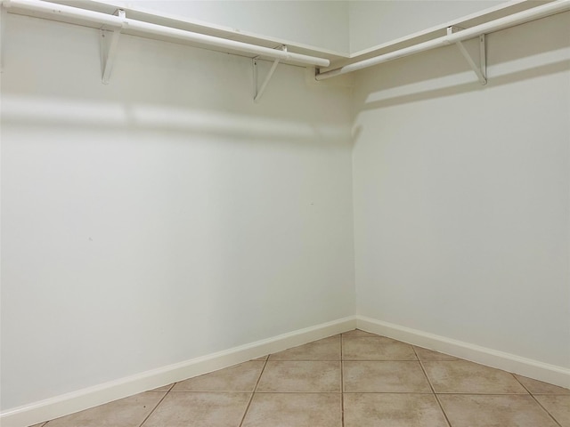 11530 Bellerive Dr, Houston, TX 77072 - spacious closet featuring light tile patterned floors