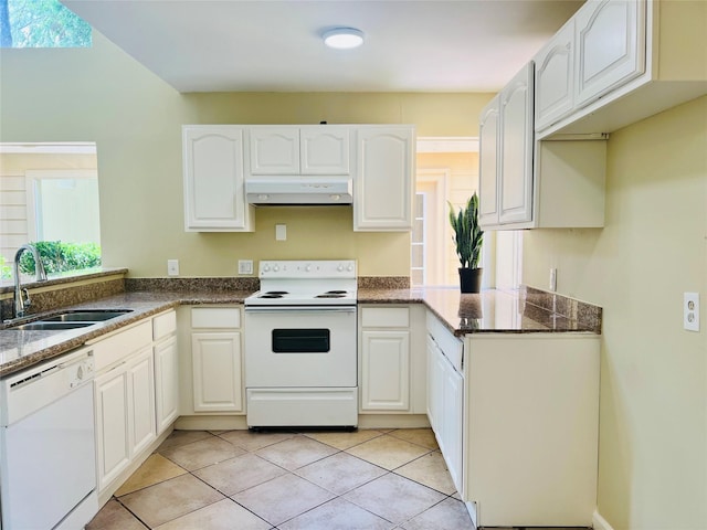 11530 Bellerive Dr, Houston, TX 77072 - kitchen featuring white appliances, under cabinet range hood, dark stone counters, and light tile patterned floors