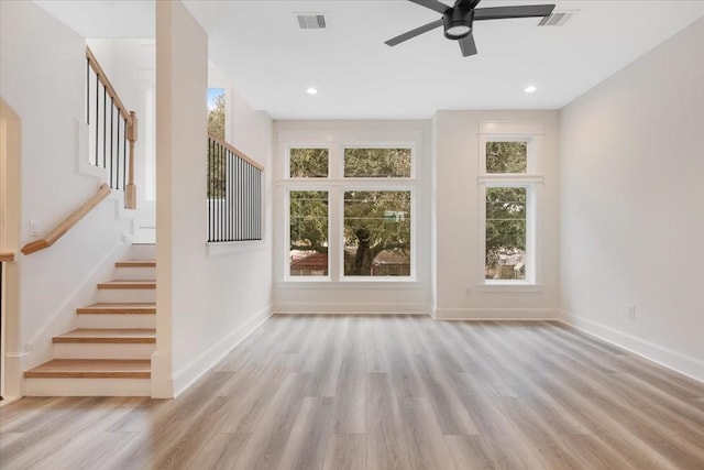 6723 Saint Augustine St, Houston, TX 77021 - unfurnished living room with wood finished floors, healthy amount of natural light, stairway, a ceiling fan, and recessed lighting