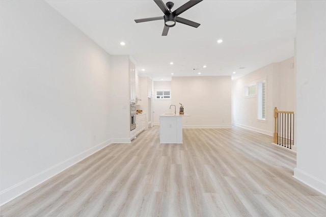 6723 Saint Augustine St, Houston, TX 77021 - unfurnished living room featuring light wood-style flooring, a ceiling fan, and recessed lighting