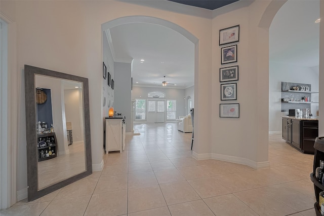 4227 Lodge Ranch Ct, Fulshear, TX 77441 - corridor featuring arched walkways, light tile patterned floors, crown molding, and recessed lighting