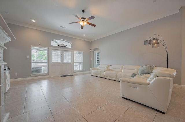 4227 Lodge Ranch Ct, Fulshear, TX 77441 - living room featuring a ceiling fan, arched walkways, crown molding, light tile patterned floors, and recessed lighting