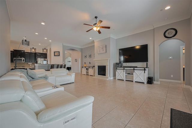 4227 Lodge Ranch Ct, Fulshear, TX 77441 - living area featuring arched walkways, ceiling fan, light tile patterned floors, crown molding, and recessed lighting