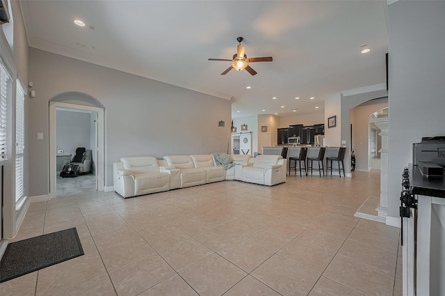 4227 Lodge Ranch Ct, Fulshear, TX 77441 - living area with arched walkways, crown molding, ceiling fan, light tile patterned floors, and recessed lighting