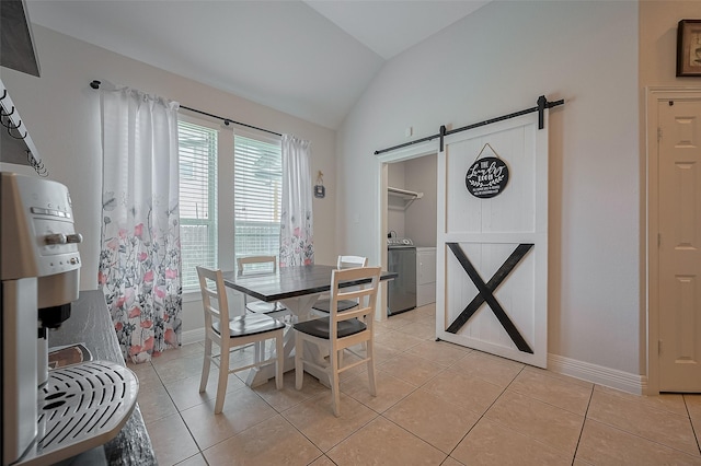 4227 Lodge Ranch Ct, Fulshear, TX 77441 - dining space with a barn door, vaulted ceiling, light tile patterned floors, and washer / dryer