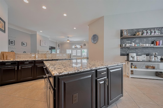 4227 Lodge Ranch Ct, Fulshear, TX 77441 - kitchen with light tile patterned flooring, light stone counters, ceiling fan, recessed lighting, and crown molding