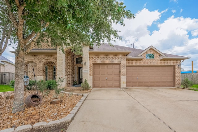 4227 Lodge Ranch Ct, Fulshear, TX 77441 - view of front of home with brick siding, an attached garage, driveway, and roof with shingles