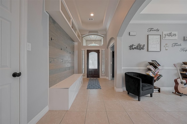 4227 Lodge Ranch Ct, Fulshear, TX 77441 - foyer entrance with arched walkways, ornamental molding, light tile patterned flooring, wooden walls, and recessed lighting