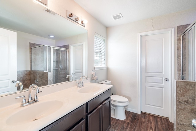 15915 Mountain Willow Way, Cypress, TX 77429 - bathroom featuring tiled shower, double vanity, and wood finished floors