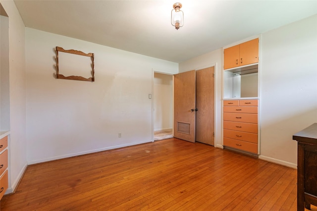 122 Blossom St, Lake Jackson, TX 77566 - unfurnished bedroom featuring light wood finished floors and baseboards