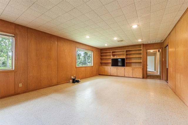 122 Blossom St, Lake Jackson, TX 77566 - unfurnished living room with built in features, wooden walls, and recessed lighting