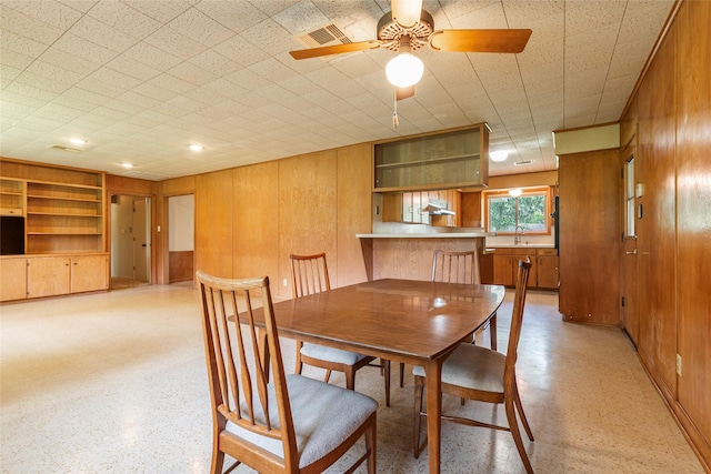 122 Blossom St, Lake Jackson, TX 77566 - dining room with wooden walls and a ceiling fan