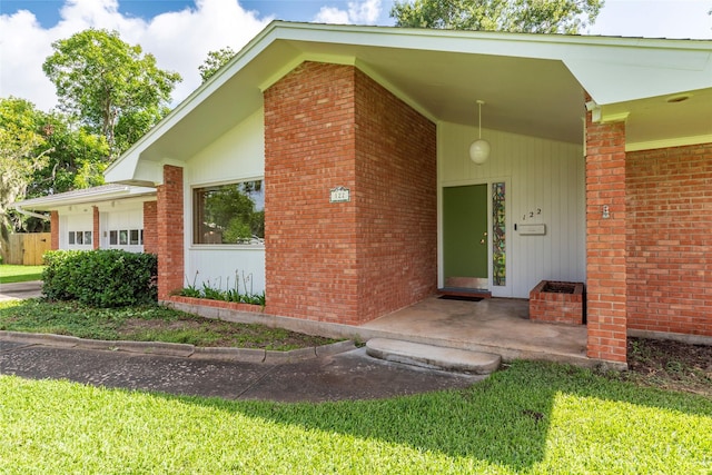 122 Blossom St, Lake Jackson, TX 77566 - view of exterior entry with brick siding and covered porch