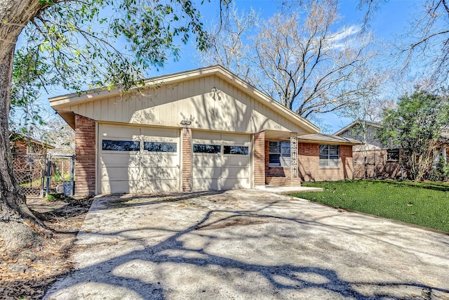 6763 Glen Rock Dr, Houston, TX 77087 - view of front of home with driveway, brick siding, a garage, and a gate