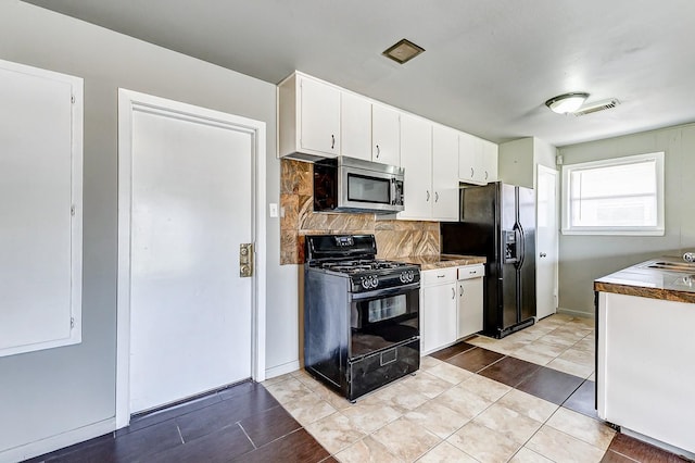 6763 Glen Rock Dr, Houston, TX 77087 - kitchen featuring black appliances, decorative backsplash, white cabinets, and light tile patterned flooring