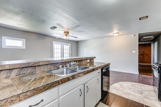 6763 Glen Rock Dr, Houston, TX 77087 - kitchen featuring tile countertops, black dishwasher, white cabinets, a ceiling fan, and range with gas cooktop
