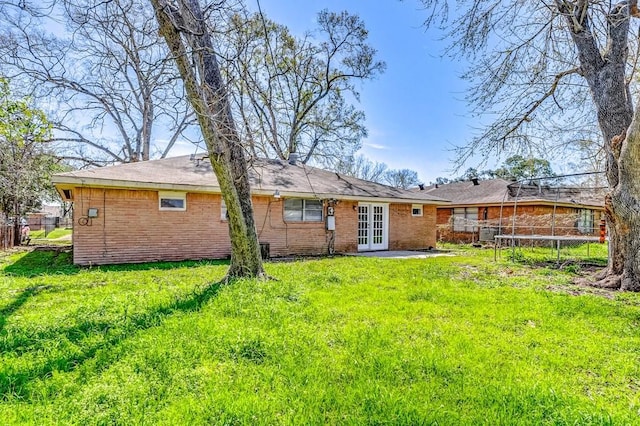 6763 Glen Rock Dr, Houston, TX 77087 - rear view of property featuring french doors, a trampoline, and brick siding