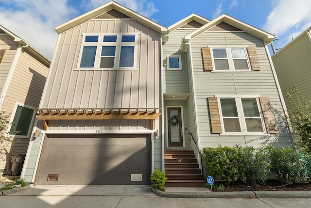 3342 Pinemont Dr, Houston, TX 77018 - townhome / multi-family property with board and batten siding, concrete driveway, and an attached garage