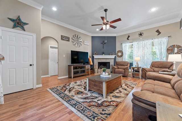 22206 Lantana Dr, Magnolia, TX 77355 - living room featuring a ceiling fan, arched walkways, light wood finished floors, crown molding, and recessed lighting