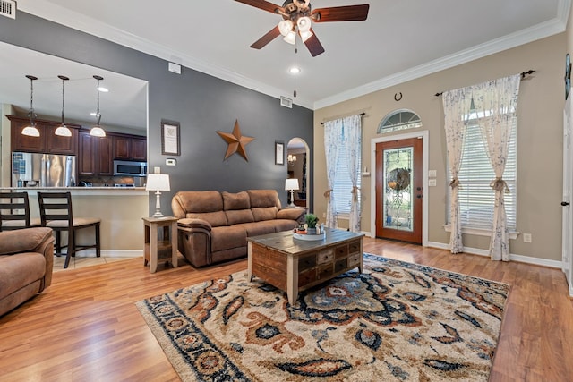 22206 Lantana Dr, Magnolia, TX 77355 - living room with a ceiling fan, arched walkways, light wood-style flooring, crown molding, and recessed lighting