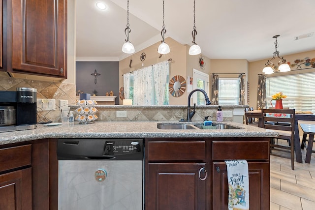 22206 Lantana Dr, Magnolia, TX 77355 - kitchen with dishwasher, dark brown cabinetry, backsplash, pendant lighting, and light stone counters