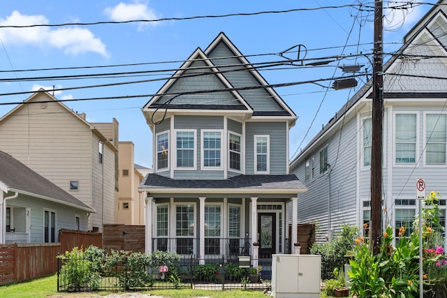 2111 Beall St, Houston, TX 77008 - view of front of home with covered porch, a fenced front yard, and a shingled roof