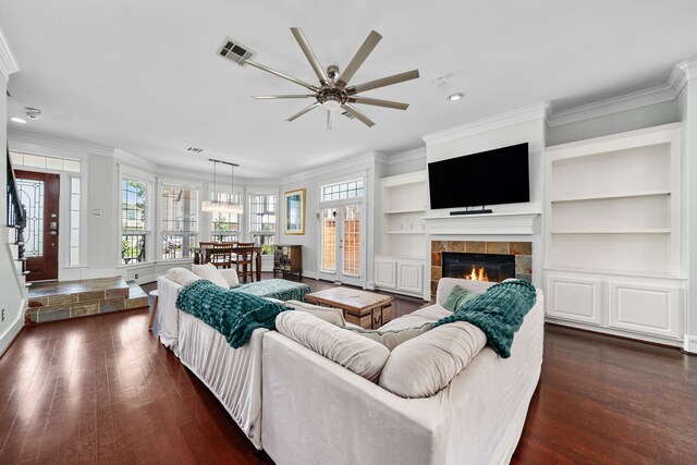 2111 Beall St, Houston, TX 77008 - living room featuring dark wood-style flooring, ornamental molding, a ceiling fan, a tile fireplace, and recessed lighting