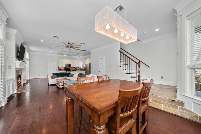 2111 Beall St, Houston, TX 77008 - dining space featuring recessed lighting, a ceiling fan, a fireplace with flush hearth, stairs, and ornamental molding