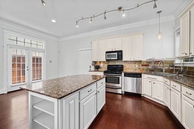 2111 Beall St, Houston, TX 77008 - kitchen featuring stainless steel appliances, open shelves, decorative backsplash, dark wood finished floors, and crown molding