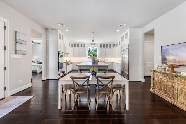 8550 Tombron Grove Rd, Magnolia, TX 77354 - dining room featuring dark wood-style floors and recessed lighting