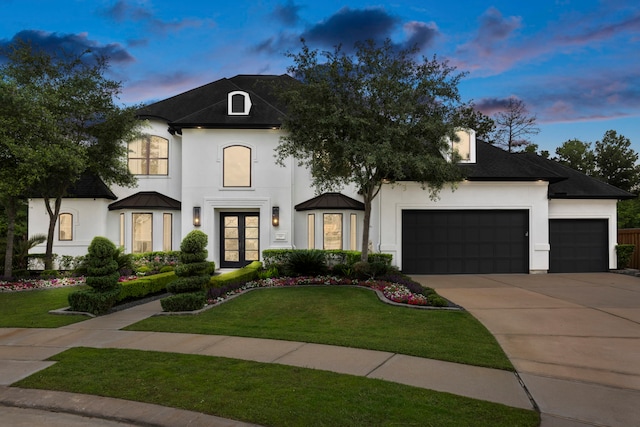 8550 Tombron Grove Rd, Magnolia, TX 77354 - french country home featuring stucco siding, a garage, french doors, and concrete driveway
