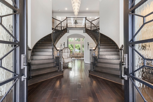 8550 Tombron Grove Rd, Magnolia, TX 77354 - foyer featuring stairway, wood finished floors, a towering ceiling, recessed lighting, and arched walkways