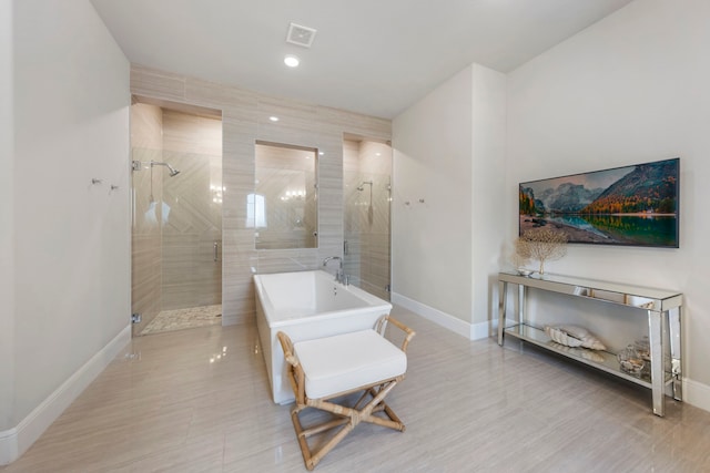 8550 Tombron Grove Rd, Magnolia, TX 77354 - bathroom featuring a freestanding bath and a shower stall