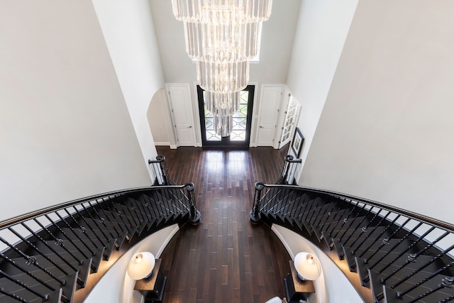 8550 Tombron Grove Rd, Magnolia, TX 77354 - entrance foyer with a chandelier, a high ceiling, stairs, hardwood / wood-style flooring, and arched walkways